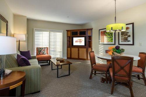 a living room with a couch and a table at Tahiti Village Resort & Spa in Las Vegas