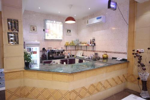 a kitchen with a sink and a counter top at Nakhil Moon Serviced Apartments in Wadi Al Dawasir