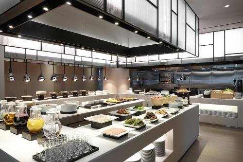 a restaurant with many plates of food on display at Shilla Stay Seocho Gangnam Station in Seoul