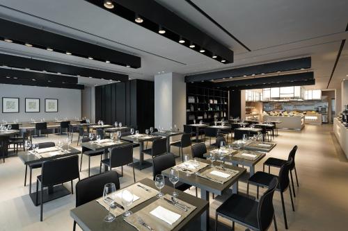 a restaurant with tables and chairs in a room at Shilla Stay Seocho Gangnam Station in Seoul