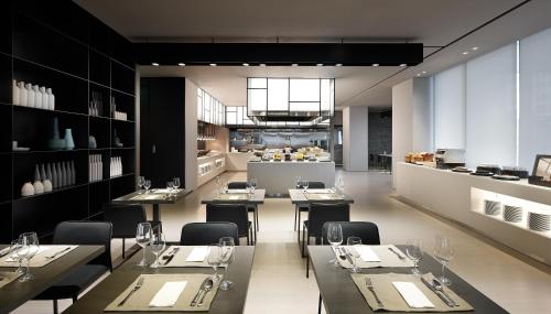 a restaurant with tables and chairs and a kitchen at Shilla Stay Seocho Gangnam Station in Seoul