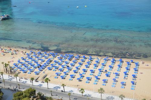 an overhead view of a beach with chairs and umbrellas at Apartamentos Oasis Benidorm in Benidorm