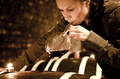 a woman is eating a spoon of chocolate at Penzion - Vinařství Hanuš in Blučina