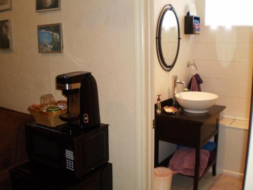 a bathroom with a coffee maker and a sink at Grandeur Farm Retreat in Marshallville