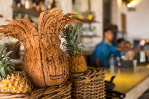 a pile of pineapples sitting on top of a counter at Wilson's Retreat in Gili Trawangan