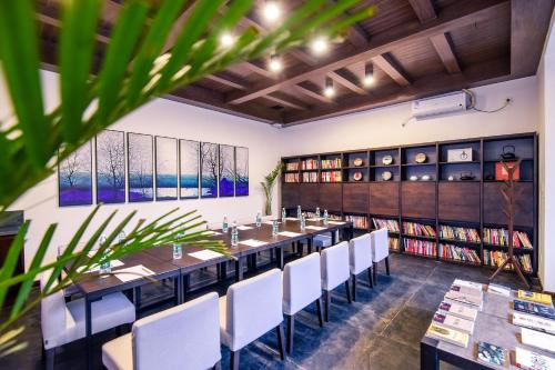 a long dining room with a long table and chairs at Elsewhere Hotel Inn North Street Branch in Pingyao