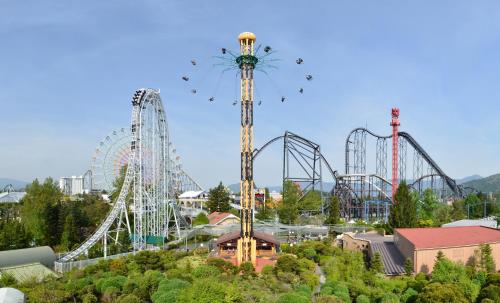 an amusement park with two rollercoasters and a roller coaster at HOTEL MYSTAYS Fuji Onsen Resort in Fujiyoshida