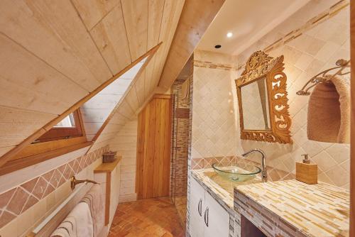 a bathroom with a sink and a staircase at La porte bleue in Trouville-sur-Mer