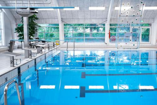 
a swimming pool with blue walls and a blue floor at Danhostel Tønder in Tønder
