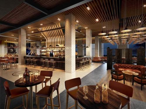 a restaurant with tables and chairs and a bar at Wyndham Grand Phu Quoc in Phu Quoc