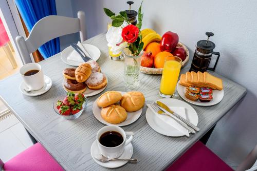 a table with breakfast foods and coffee on it at Louladakis Apartments in Kolymvari