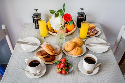 a table with breakfast foods and cups of coffee at Louladakis Apartments in Kolymvari