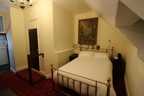 a bedroom with a bed and a painting on the wall at Appleby Castle in Appleby