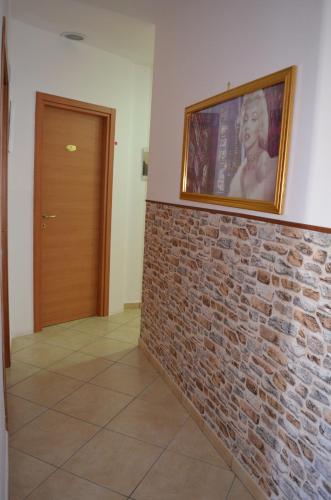a picture of a woman on a brick wall at Campi Flegrei House in Naples