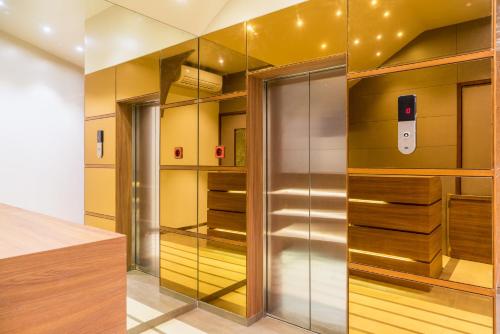 a walk in closet with an iphone on the wall at Treebo Olive Nest in Mumbai
