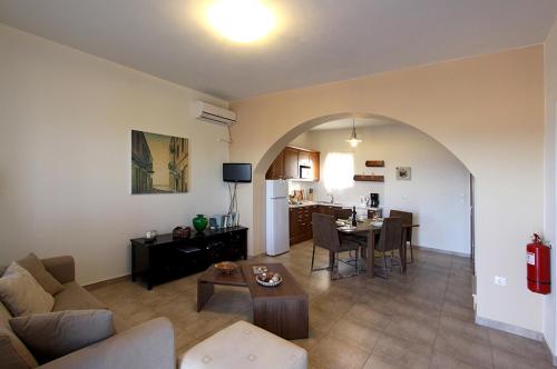 a living room with a couch and a table at Trochalo Villas 2 in Stoupa