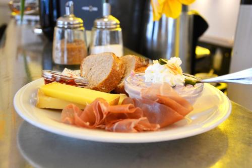 a plate of food with meats cheese and bread at Gasthaus zum Guten Glück in Zurich