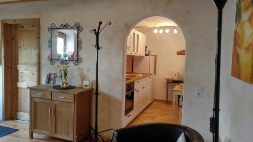 a kitchen with an archway in the middle of a room at Maifeld-Fewo Rhapsodie in Kerben