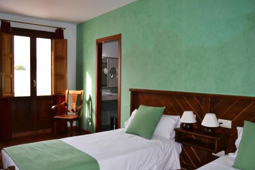 Postel nebo postele na pokoji v ubytování Hotel Rural El Moral