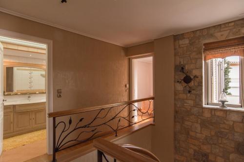 a staircase in a home with a stone wall at Villa Maira Luxurious with private swimming pool in Korfos