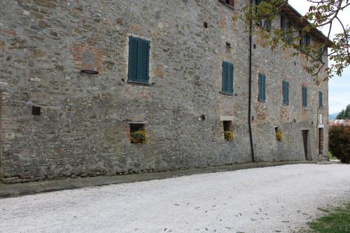 a large brick building with windows on it at Fattoria di Rigone in Coltavolino
