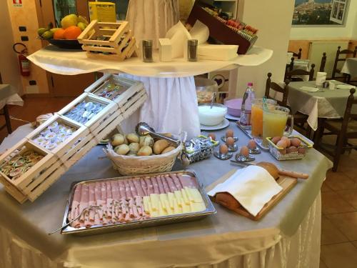 a table with a buffet of food on it at Hotel Vela Azzurra in Malcesine