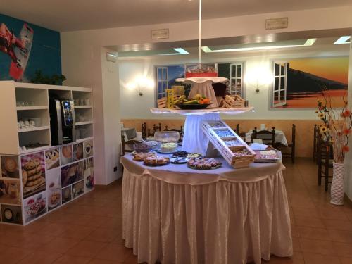 a table with food on it in a room at Hotel Vela Azzurra in Malcesine
