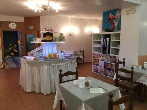 a dining room with two tables and a cake on a ceiling at Hotel Vela Azzurra in Malcesine