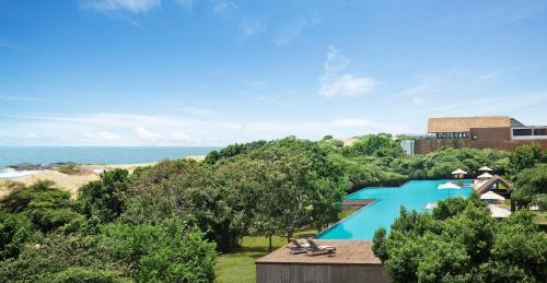 an overhead view of a swimming pool with the ocean in the background at Jetwing Yala in Yala