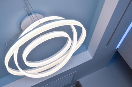 a white tube light hanging from a ceiling at Hotel Miau in Madrid