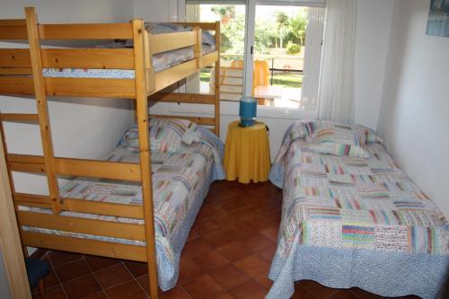 a bedroom with two bunk beds in a room at Apartamento en Familia in Comarruga