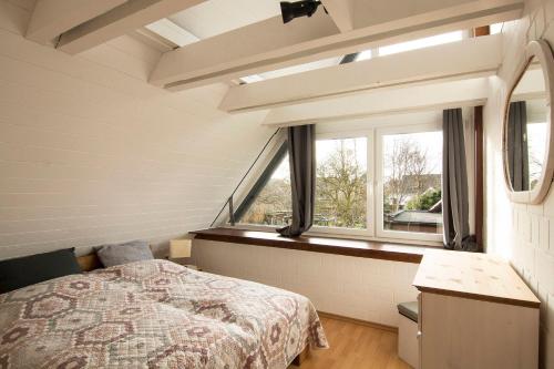 a bedroom with a bed and a large window at Ferienwohnung Gilg in Cuxhaven