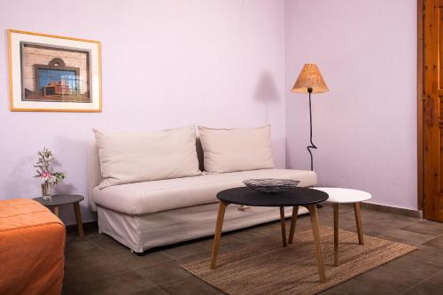 a living room with a couch and a table at 4Elies apartments in Vourvourou