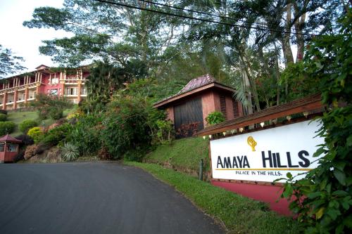 a sign on the side of a road in front of a house at Amaya Hills Kandy in Kandy