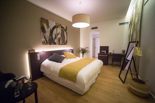 a bedroom with a bed and a painting on the wall at Best Western Premier Le Domaine de Montjoie in Ramonville-Saint-Agne