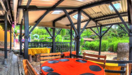 a table and chairs in a pavilion with a lady bug table at Finca La Tobita Eco Hotel in Toca
