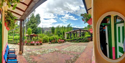 a house with a patio with a view of a garden at Finca La Tobita Eco Hotel in Toca