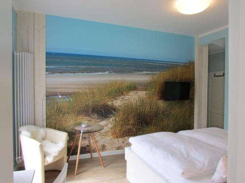 a bedroom with a bed and a view of a beach at Gästehaus Muhl in Strukkamp auf Fehmarn