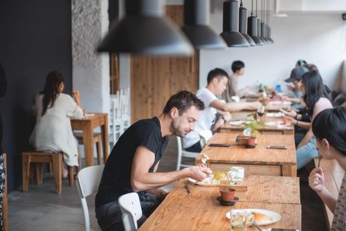 a group of people sitting at a table eating food at Star Hostel Taipei Main Station in Taipei
