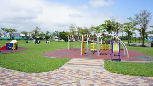 a playground in a park with a colorful playground at Warm Home in Taitung City