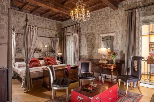 a living room filled with furniture and a fireplace at The Inn At The Roman Forum in Rome