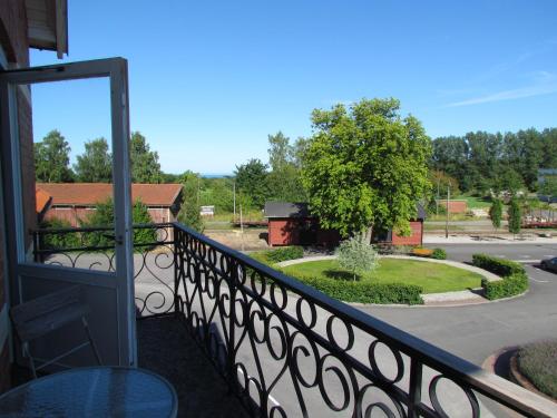 a balcony with a view of a yard at Vitaby Järnvägshotell in Vitaby