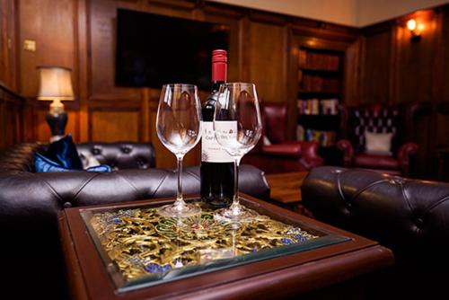 two wine glasses sitting on top of a table at The Old Lodge in Malton