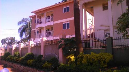 a pink building with balconies on the side of it at 2 Bedroom down White in Kampala