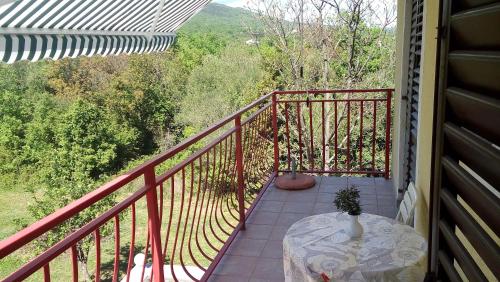 a balcony with a table and a view at Apartments Nina in Ravni