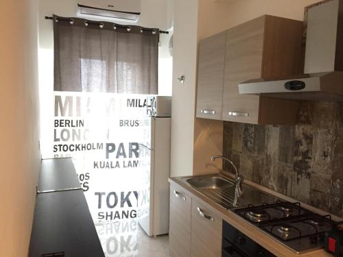 a kitchen with a sink and a refrigerator at Murena Apartments & rooms in Rome