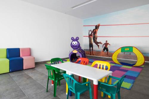 a dining room with a table and chairs and a painting at Hotel Stadium Leon in León