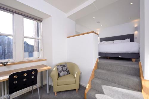 a room with a bed and a stairway with a bedroom at Destiny Scotland - Broughton St Lofts in Edinburgh