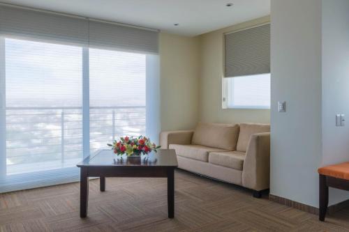 a living room with a couch and a coffee table at Hotel Stadium Leon in León