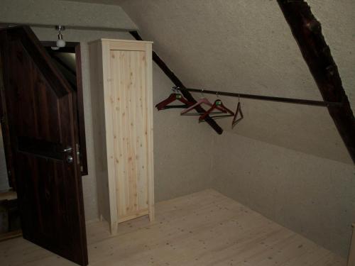 an attic room with a staircase with two pairs of shoes at Aaduaida Holiday House in Suure-Rootsi